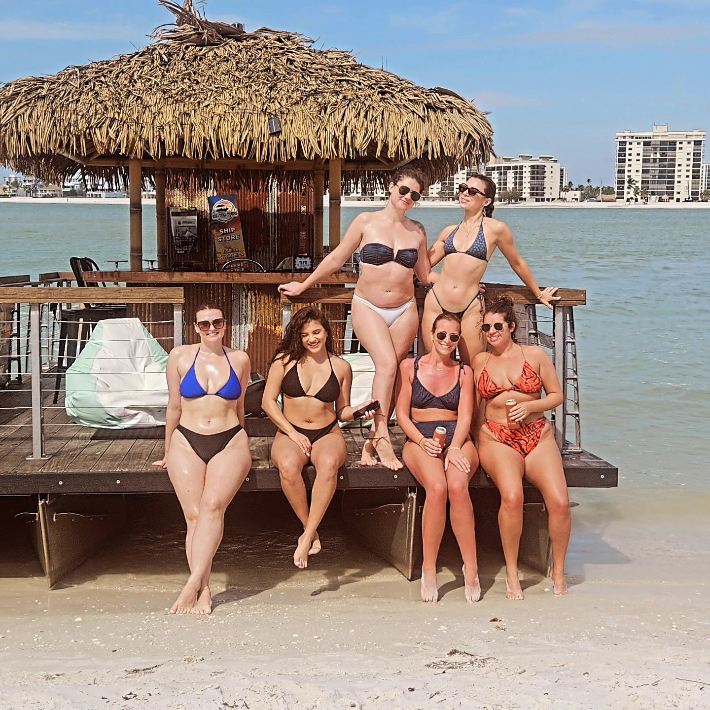 Friends enjoying a beach stop with the Big Tiki Boat